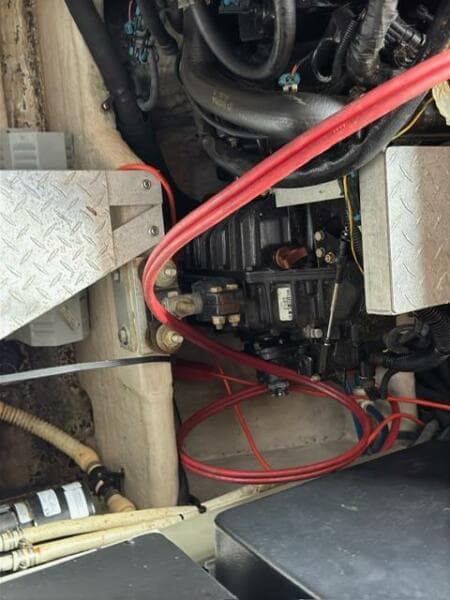 Engine compartment of a 2003 Sea Ray 380 Sundancer with visible wiring and components.