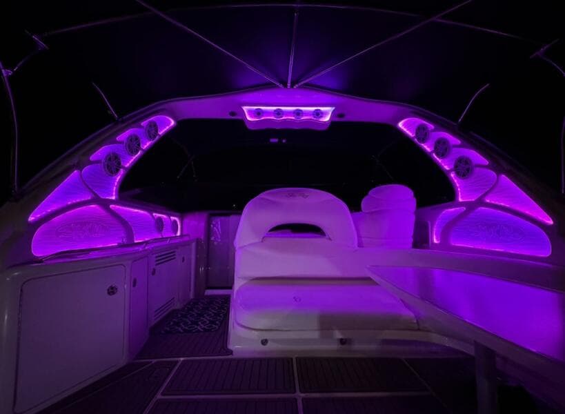 Interior of 2003 Sea Ray 380 Sundancer with vibrant purple LED lighting.