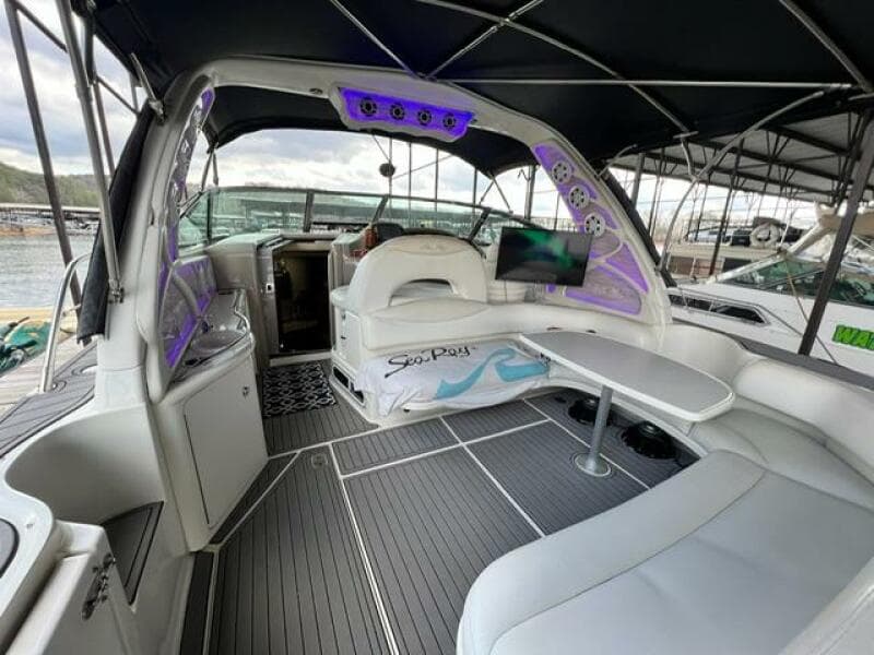 2003 Sea Ray 380 Sundancer interior with seating, table, and ambient lighting.