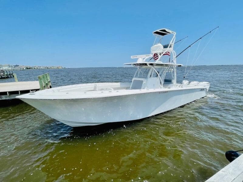 2020 SeaHunter 39 Tournament boat on water, clear sky, fishing rods visible.