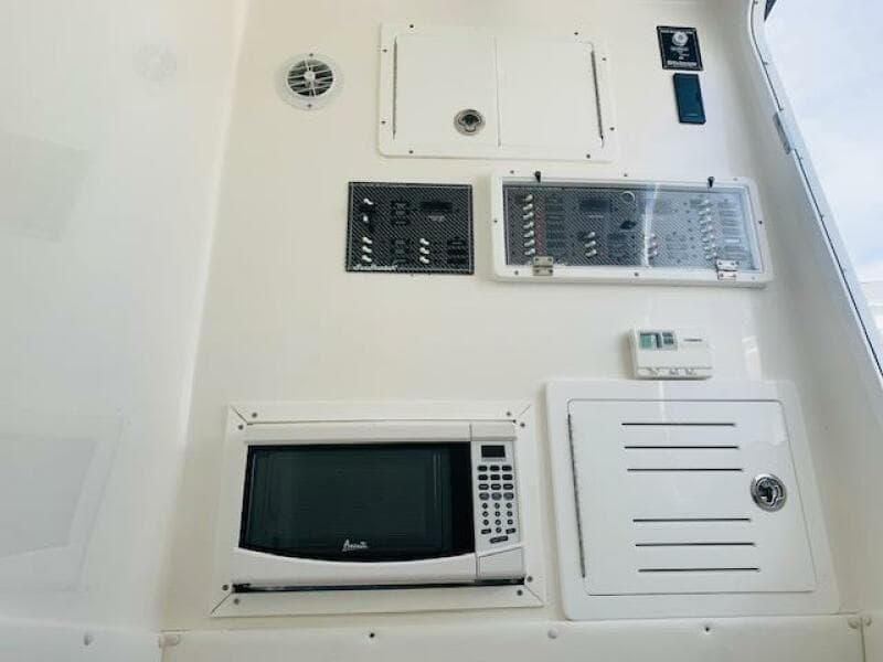 Control panel and microwave on 2020 SeaHunter 39 Tournament boat interior.