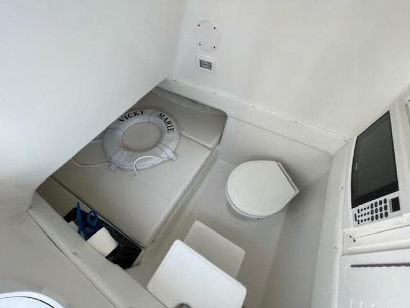 Interior of 2020 SeaHunter 39 Tournament boat with seating, toilet, and life preserver.
