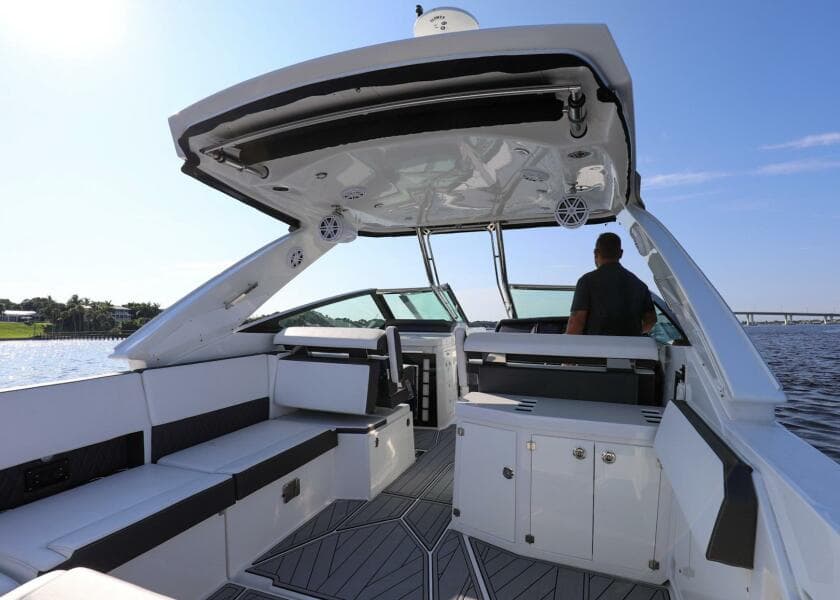 2023 Monterey 385 Super Sport boat interior with seating and helm, on a sunny day.