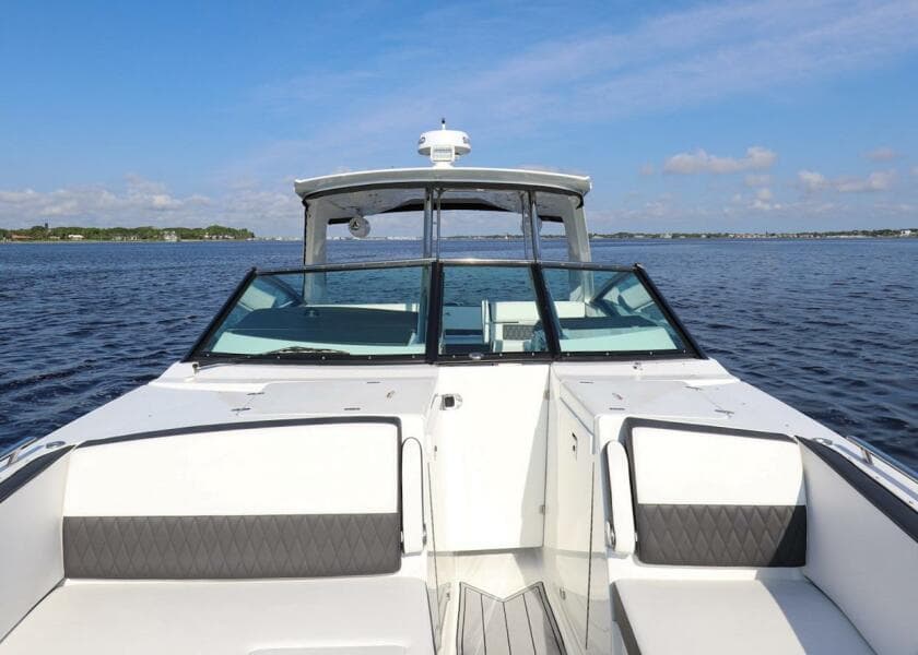 2023 Monterey 385 Super Sport boat on calm water under a clear blue sky.