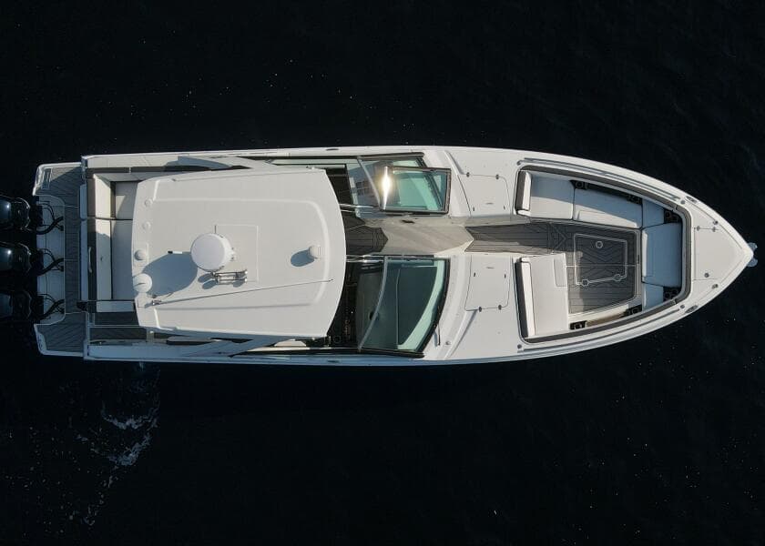 Aerial view of 2023 Monterey 385 Super Sport boat on dark water.