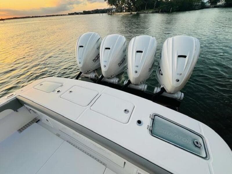 2024 Regulator 41 boat with four powerful outboard engines on a serene water backdrop.