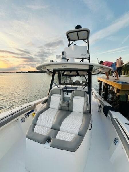 2024 Regulator 41 boat with luxurious seating, docked at sunset.