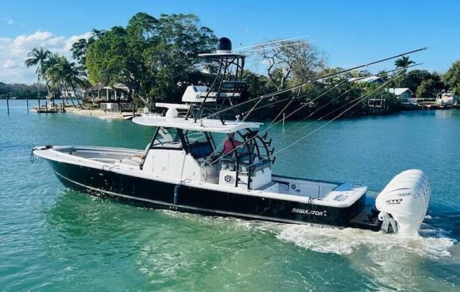 2024 Regulator 41 boat cruising in a scenic tropical waterway.