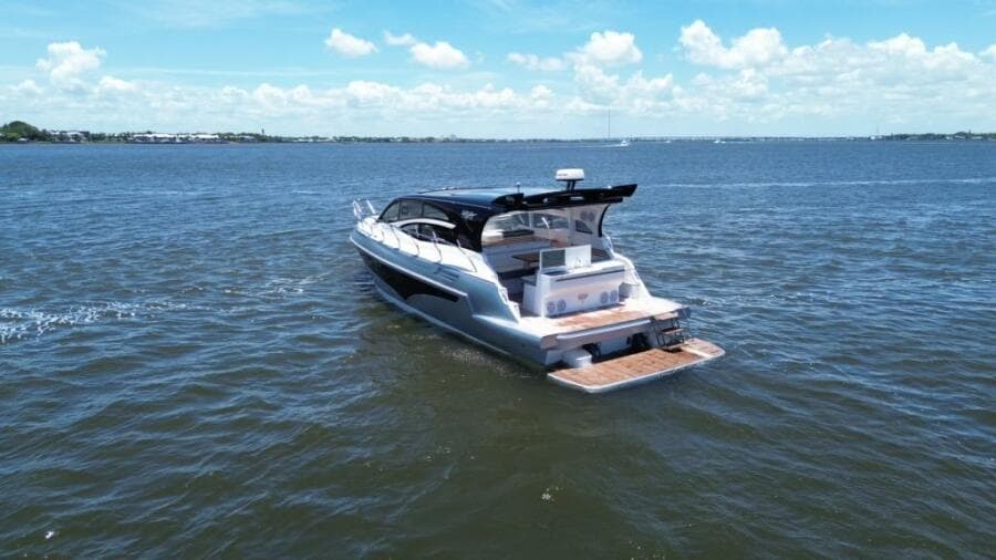 Luxury yacht Real 40 HT 2025 cruising on open water under a clear blue sky.