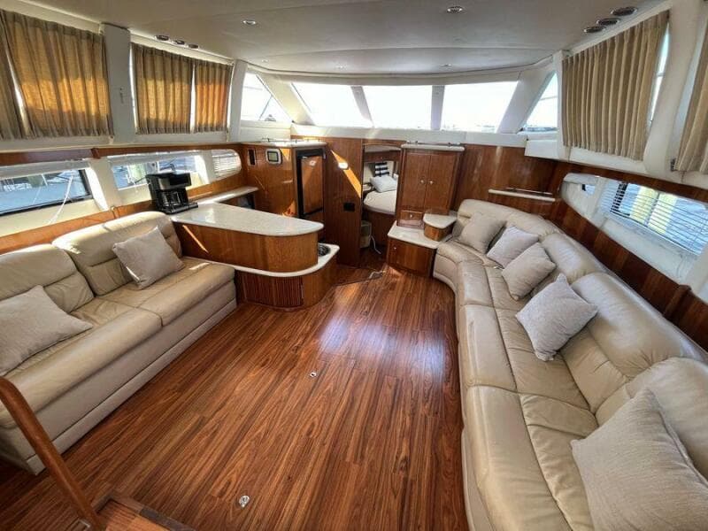 Luxurious interior of 2000 Carver 396 Motor Yacht with plush seating and wood finishes.