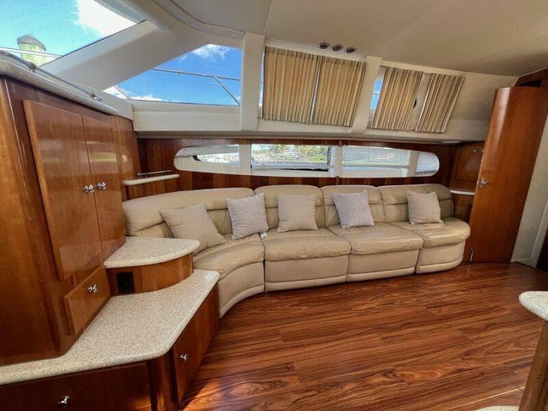 Luxurious interior of 2000 Carver 396 Motor Yacht with plush seating and elegant wood finishes.