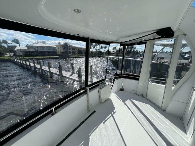 2000 Carver 396 Motor Yacht interior with marina view through large windows.