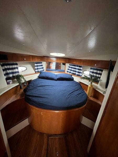 Interior of 2000 Carver 396 Motor Yacht with cozy bedroom and nautical decor.