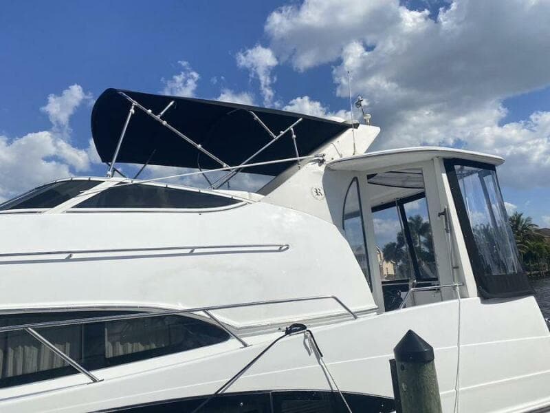 2000 Carver 396 Motor Yacht with canopy, docked under a blue sky.