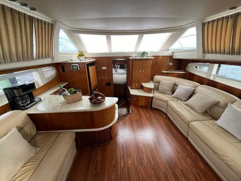 Luxurious interior of 2000 Carver 396 Motor Yacht with plush seating and wood accents.