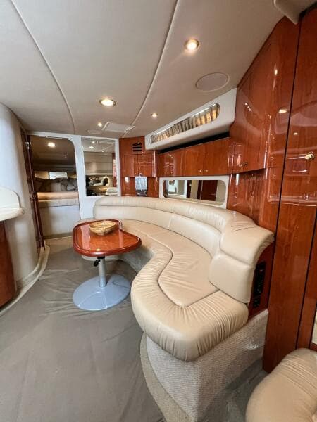 Luxurious interior of 2001 Sea Ray 380 Sundancer with leather seating and wooden accents.