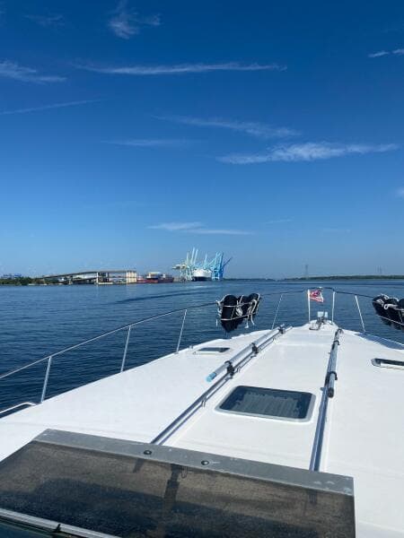 1993 Sea Ray 440 Sundancer cruising on calm waters under a clear blue sky.