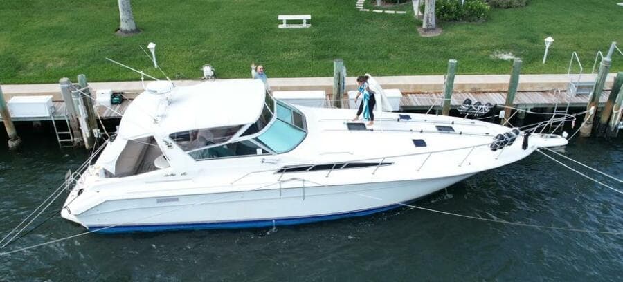 1993 Sea Ray 440 Sundancer yacht docked at marina, aerial view.