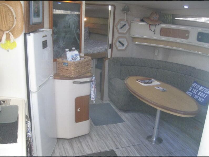 Interior of 1993 Sea Ray 440 Sundancer yacht with kitchenette and seating area.