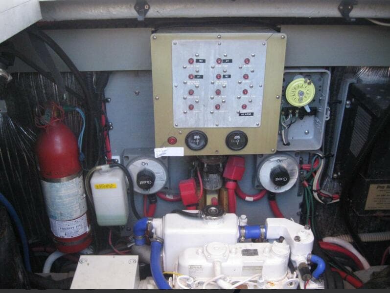 Engine room of 1993 Sea Ray 440 Sundancer with control panel and fire extinguisher.