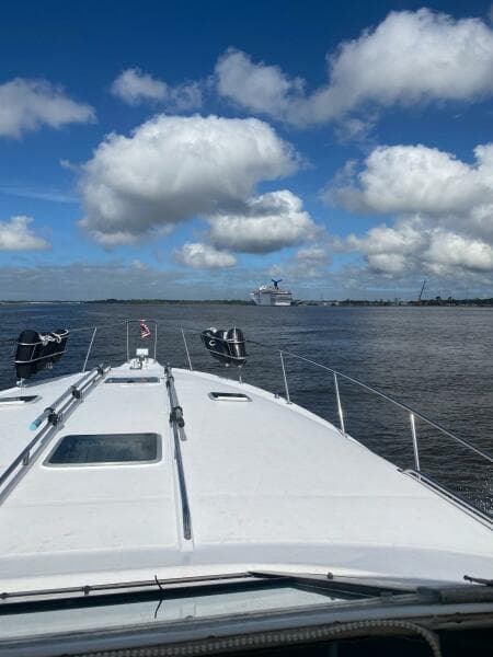 1993 Sea Ray 440 Sundancer cruising on a sunny day with scattered clouds.