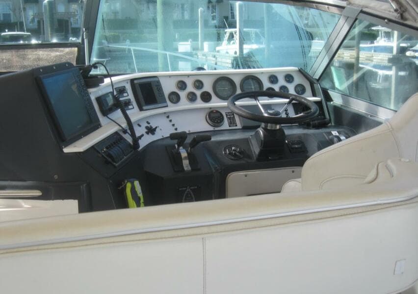 1993 Sea Ray 440 Sundancer helm with steering wheel and control panel.