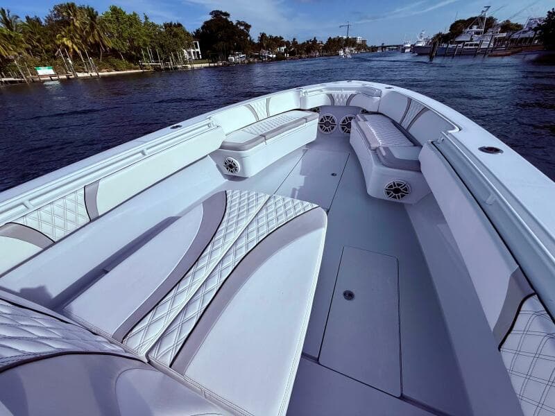 2024 Contender 39 ST boat interior with luxurious seating on a calm waterway.
