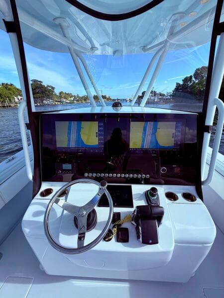 2024 Contender 39 ST boat helm with advanced navigation system and steering wheel.