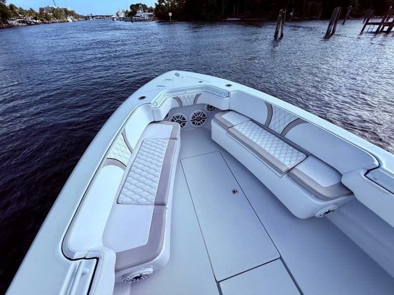 2024 Contender 39 ST boat interior with luxurious seating on a calm waterway.