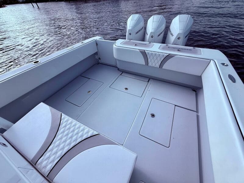 2024 Contender 39 ST boat with spacious deck and triple outboard engines on water.