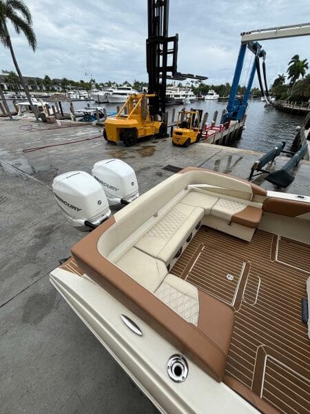 2013 Statement 35 Center Console boat with Mercury engines at a marina dock.