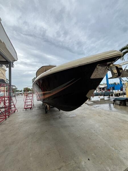 2013 Statement 35 Center Console boat on dry dock under cloudy sky.