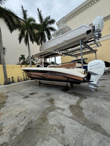 2013 Statement 35 Center Console boat on a dock with palm trees in the background.