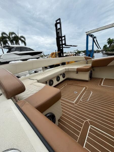 2013 Statement 35 Center Console boat interior with brown and beige seating, docked near palm trees.