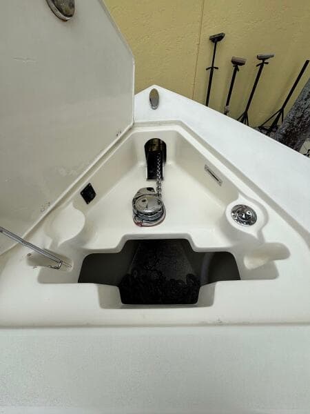 Anchor compartment of 2013 Statement 35 Center Console boat, featuring winch and chain storage.