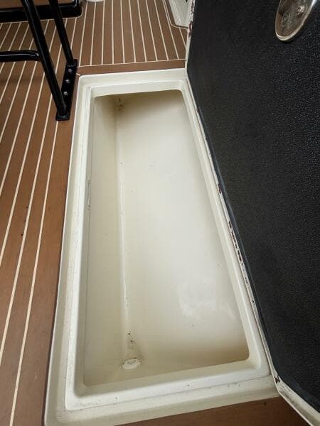 Open storage compartment on 2013 Statement 35 Center Console boat deck.