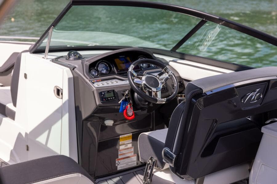 2023 Monterey 255 Super Sport boat interior with steering wheel and dashboard, on water.