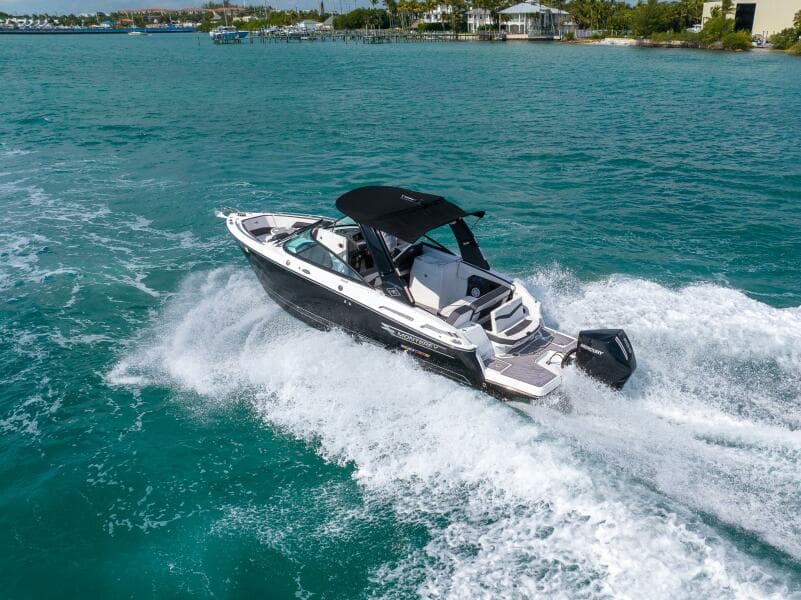2023 Monterey 255 Super Sport boat cruising on clear blue water.