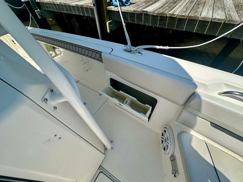 2019 Wellcraft 262 Fisherman boat interior with storage compartment and speaker.