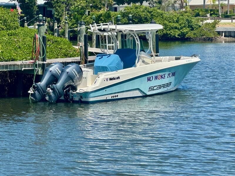 2019 Wellcraft 262 Fisherman boat docked with twin engines, labeled "No Woke Zone."