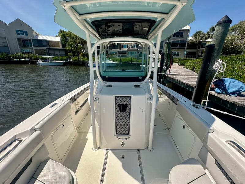 2019 Wellcraft 262 Fisherman boat docked, featuring spacious deck and modern design.