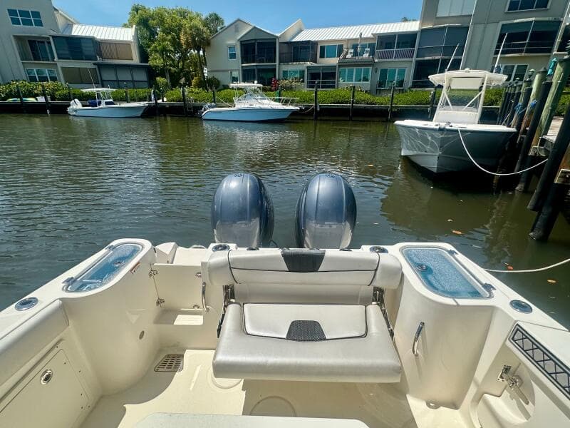 2019 Wellcraft 262 Fisherman boat docked in a marina with twin engines.