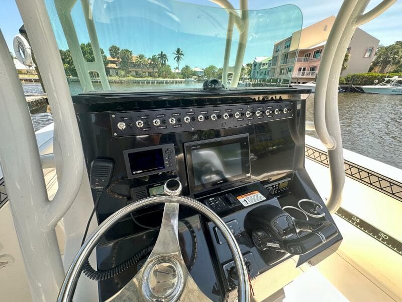 2019 Wellcraft 262 Fisherman boat console with steering wheel and navigation equipment.