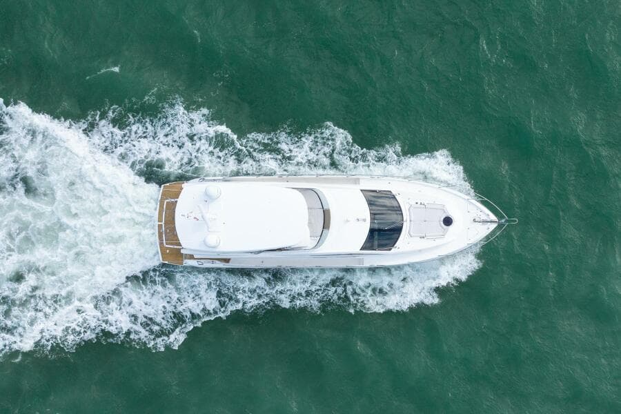 Aerial view of 2016 Sunseeker Manhattan 65 yacht cruising on the ocean.