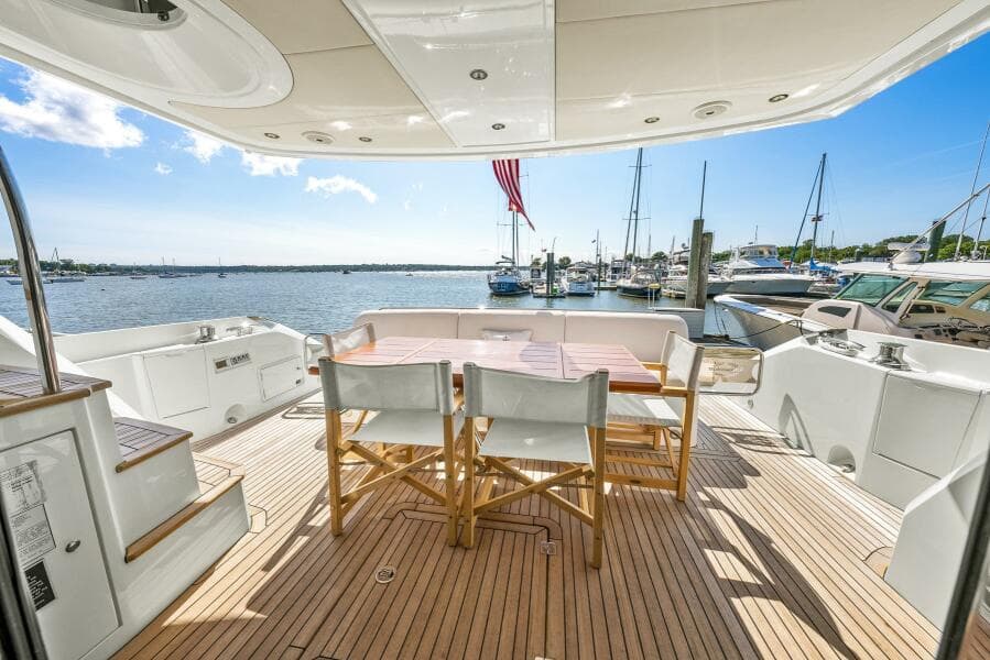 Sunseeker Manhattan 65 yacht deck with seating, overlooking marina, 2016 model.