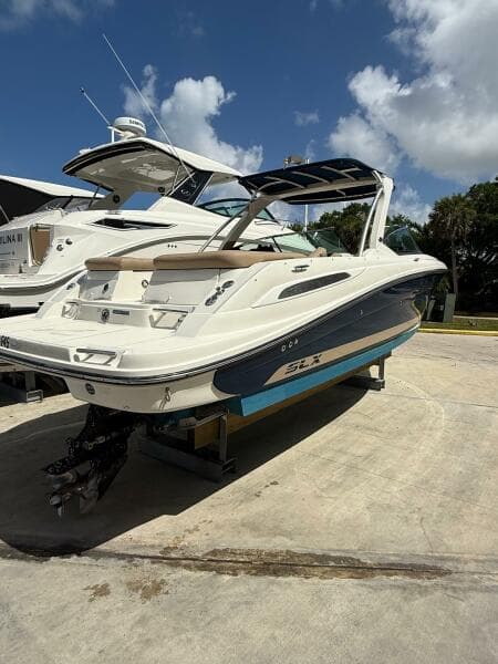 2014 Sea Ray 270 SLX boat on display under a clear blue sky.