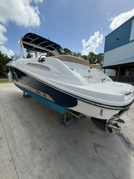 2014 Sea Ray 270 SLX boat on trailer, white and blue, parked outdoors.