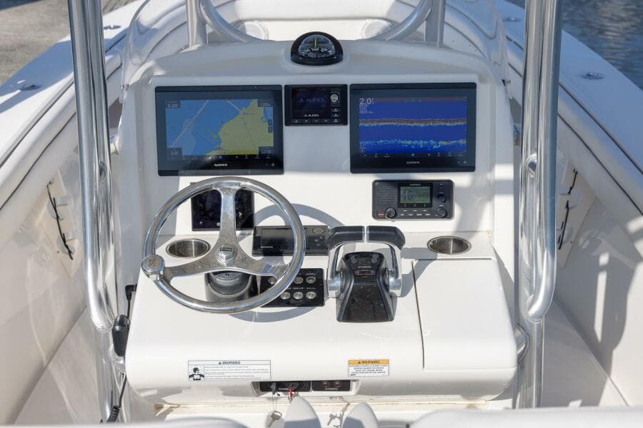 2018 Jupiter 26 FS boat console with dual navigation screens and steering wheel.