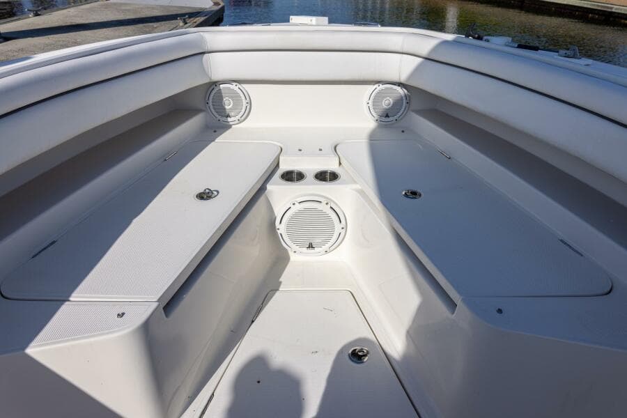 Bow seating area of 2018 Jupiter 26 FS boat with speakers and cup holders.