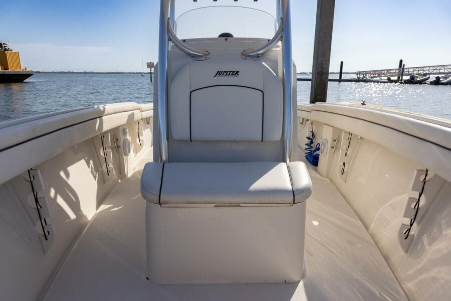 2018 Jupiter 26 FS boat interior with seating, docked by the water.